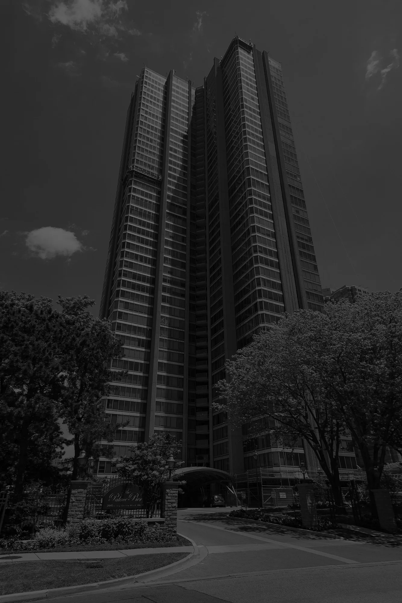 The Palace Pier residence towers rising above the surrounding trees on a clear day